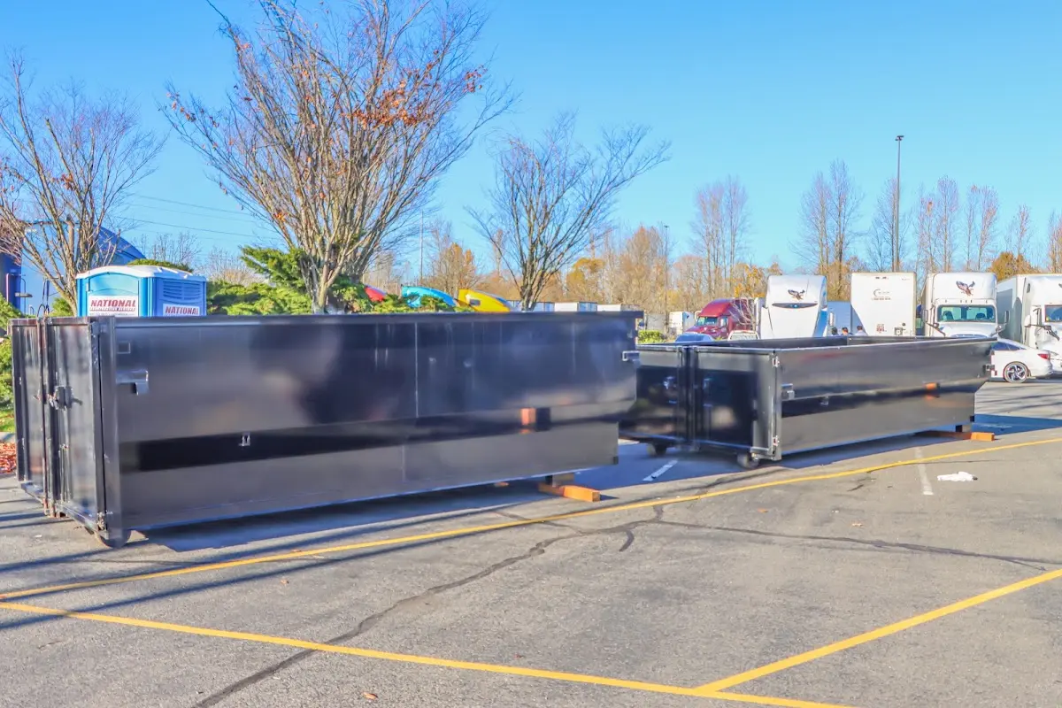 Professional dumpster rental service with roll-off container on residential driveway in The Pinery